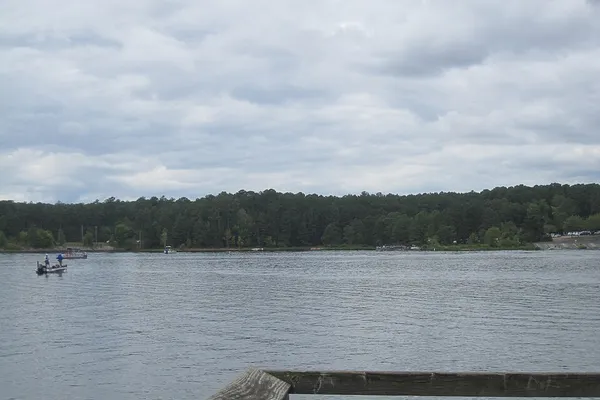 Wide view of Falls Lake under a cloudy sky at Falls Lake State Recreation Area